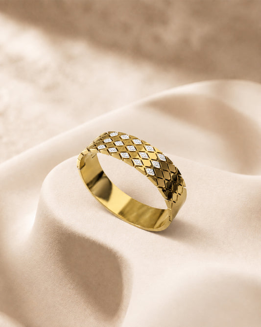 This item is a Gold Quilted Bangle Bracelet with Mother-of-Pearl Inlays.