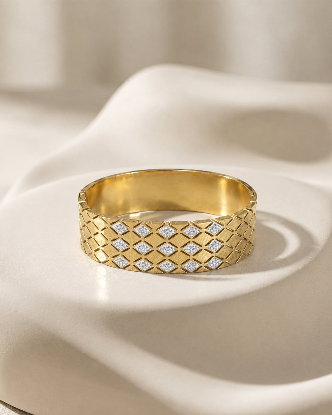 This item is a Gold Quilted Bangle Bracelet with Mother-of-Pearl Inlays.